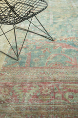 Detail of an antique Mahal's even wear, showing raspberry and sky blue leaf motifs.