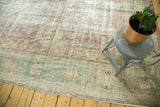Vintage Malayer carpet, worn blush, sea foam, ivory floral patterns, lower border.