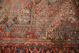 Rectilinear geometric floral pattern and border of a vintage Heriz rug, showing short pile.
