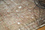 Herati motif on an antique Fereghan carpet, featuring faded red, green, and ivory with mostly even wear.