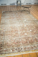 Worn antique Fereghan rug border, faded Herati motif, madder red, ivory, and visible foundation.