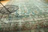 Vintage Kerman carpet with cochineal red border, faded blue and ivory palmette motifs.
