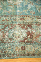 Vintage Kerman carpet section with worn sky blue, wine red palmettes, visible foundation.