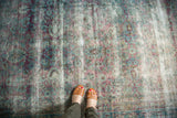 Worn surface of antique Yezd carpet with faded aubergine, teal Shah Abbas patterns.