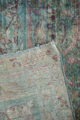 Antique Yezd carpet corner showing hand-knotted foundation and teal, aubergine palmette design.