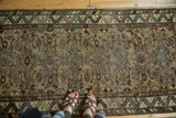Borchalou runner detail: floral geometric pattern, serrated border, camel, green, and even wear.