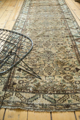 Textured pile of vintage Borchalou runner, displaying geometric floral motifs, neutral tones, and fringe.