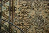 Vintage Borchalou runner detail: geometric floral field, serrated leaf, barber pole borders, softened pile.