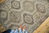 Vintage Qashqai rug, geometric medallions and abstract motifs in muted ivory and silver tones.