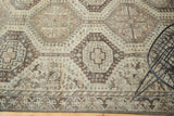 Vintage Qashqai rug detail: geometric medallions and abstract animal motifs in antique ivory, wooded tones.