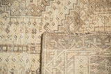 Close-up of Vintage Qashqai rug's hand-knotted backing and secured side in light tones.