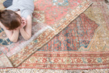 Storied patina, time-softened Herati motif, and secured edge of this antique Malayer rug.