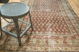 Antique Hamadan rug: Even wear shows brick red boteh, time-softened green floral border.
