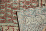 Antique Hamadan rug's worn red patterned pile and tightly hand-knotted beige foundation.