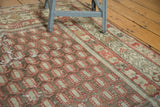 Antique Hamadan rug detail: brick red boteh pattern, floral border, and areas of foundation wear.