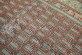 Boteh pattern detail on antique Hamadan rug, brick red, oxidized green, and soft wear.