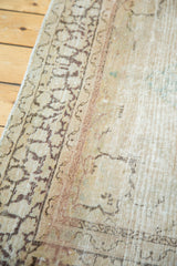 Hand-knotted Tabriz rug's charcoal border patterns and antique ivory pile with even wear.