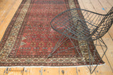 Repeating germinating flower design on a vintage Malayer rug in madder root red, blue, and beige.