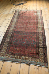 Fringed end of vintage Malayer runner, showing hand-knotted beige, blue, and brown border patterns.