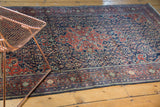 Finely woven vintage Farahan Sarouk rug showcasing madder red medallion and navy blue henna plant motifs.