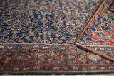 Finely woven details of vintage Farahan Sarouk rug, deep navy, madder red, and subtle green hues.