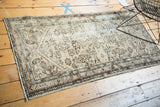 Vintage Hamadan runner border and field motifs with visible worn texture in beige and brown.