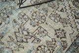 Vintage Hamadan rug's beige and brown geometric pile showing mostly even wear and light foundation.