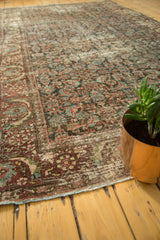 Vintage Mahal carpet corner, showing Herati motif, knot wear, and exposed foundation.