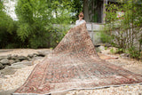 Draped vintage Mahal carpet displaying allover Herati motif, wine red, indigo, and beige with even wear.