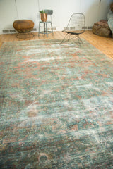 Faded raspberry, dusty teal, and blush colors on a vintage Lilihan carpet's textured, worn pile.