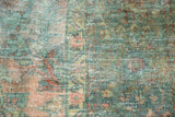 Worn pile of vintage Lilihan carpet in faded raspberry, dusty teal, with visible foundation.