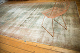 Distressed antique Kerman carpet field, highlighting pale blush, sea foam green, and visible foundation.