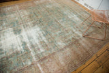 Evenly distressed antique Kerman carpet with muted floral motifs and restrung foundation.