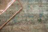 Antique Kerman rug with distressed ocean blue field, faded floral motifs, and exposed foundation.