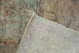 Distressed sea foam green floral pile and restrung foundation of an Antique Kerman carpet.