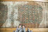 Antique Malayer runner detail showcasing aqua blue green floral trellis, antique ivory, and wine red tones with visible etching.