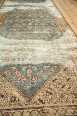 Antique Malayer rug detail: aqua, ivory, and plum floral motifs, showing etching to foundation.