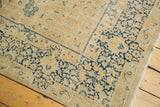 Vintage Meshed rug corner: navy floral border, beige field, and consistent pile wear.