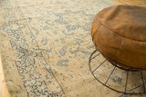 Faded navy floral bouquets on the antique ivory field of this vintage Meshed rug.