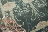 Stylized Arts and Crafts floral vines in burnt teal and pale blush on vintage Indo Donegal rug.