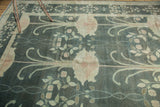 William Morris style curvilinear floral motifs in pale blush and ivory on a teal Donegal carpet.