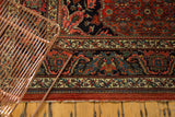 Vintage Bijar rug's European main border, rich with navy, red, and green, showing intact macrame end.