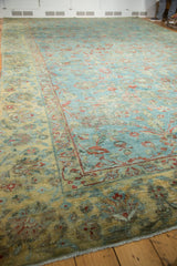 Distressed vintage Mahal carpet in faded sky blue, dusty gold, and terra cotta vinery.