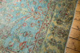 Distressed Persian Mahal carpet texture, with worn sky blue field and terra cotta floral vinery.