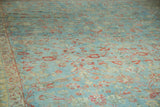 Mahal carpet's distressed texture, delicate terra cotta vinery, and sky blue field.