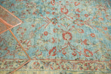 Close-up of distressed vintage Mahal carpet, sky blue with terra cotta vinery.