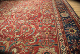 Detailed view of antique Mahal rug's cherry red field with elaborate vinery and ornate navy border.