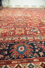 Antique Mahal close-up: intricate scrolling vinery, lotus flowers, and navy border motifs.