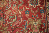 Cherry red antique Mahal carpet detail: intricate scrolling vinery with lotus flowers, foundation wear.