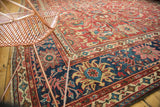 Cherry red Islimis vinery on an antique Mahal rug's field with a bold navy border.